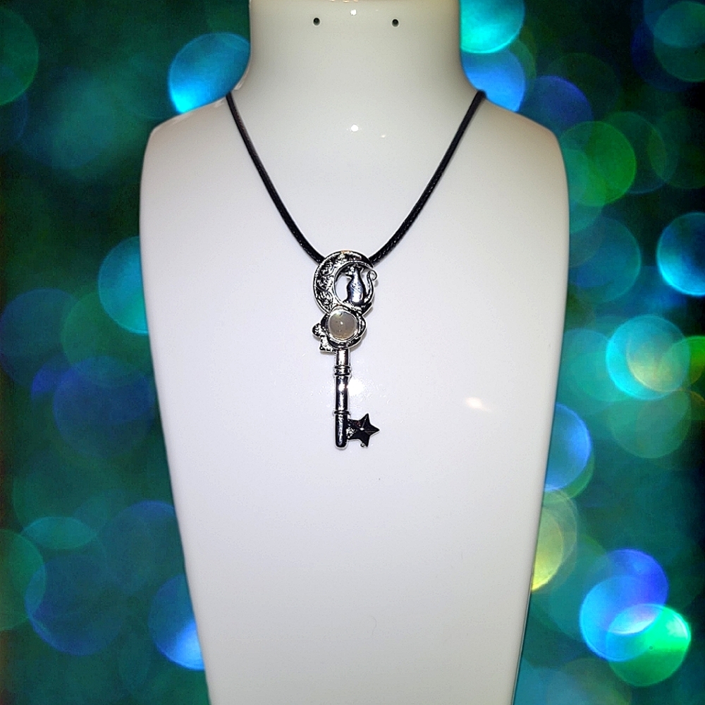 Cat Sitting on Cresent Moon Key With Moonstone